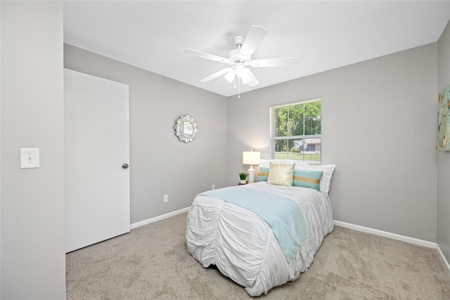 carpeted bedroom with baseboards and a ceiling fan