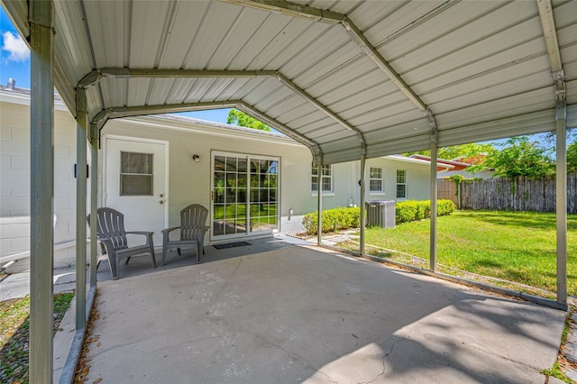 view of patio featuring fence, a carport, and central AC unit