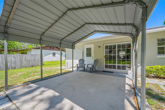 view of patio / terrace featuring fence and a detached carport