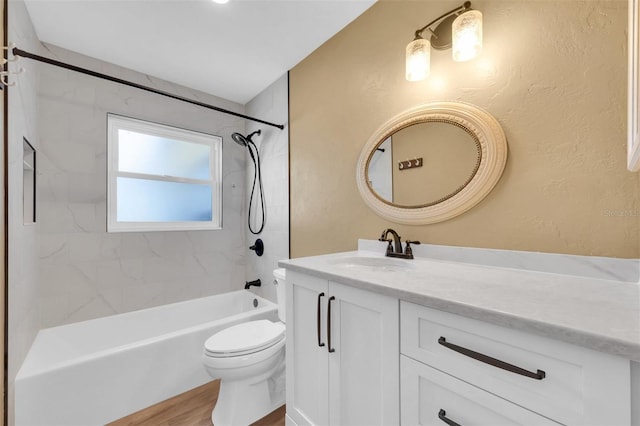 bathroom with shower / bathtub combination, vanity, toilet, and wood finished floors