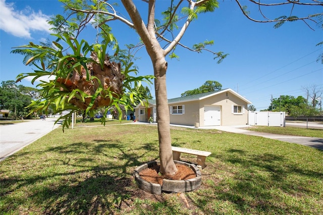 view of front of property with a garage, fence, concrete driveway, a front lawn, and a gate