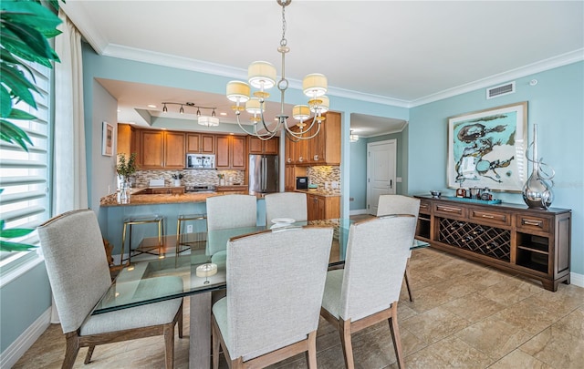 1325 Snell Isle Blvd NE Unit 607, Saint Petersburg, FL 33704 - dining room with a chandelier, baseboards, and crown molding