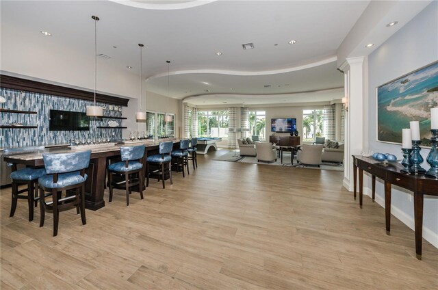 1325 Snell Isle Blvd NE Unit 607, Saint Petersburg, FL 33704 - dining space with light wood-style flooring, recessed lighting, and bar with sink