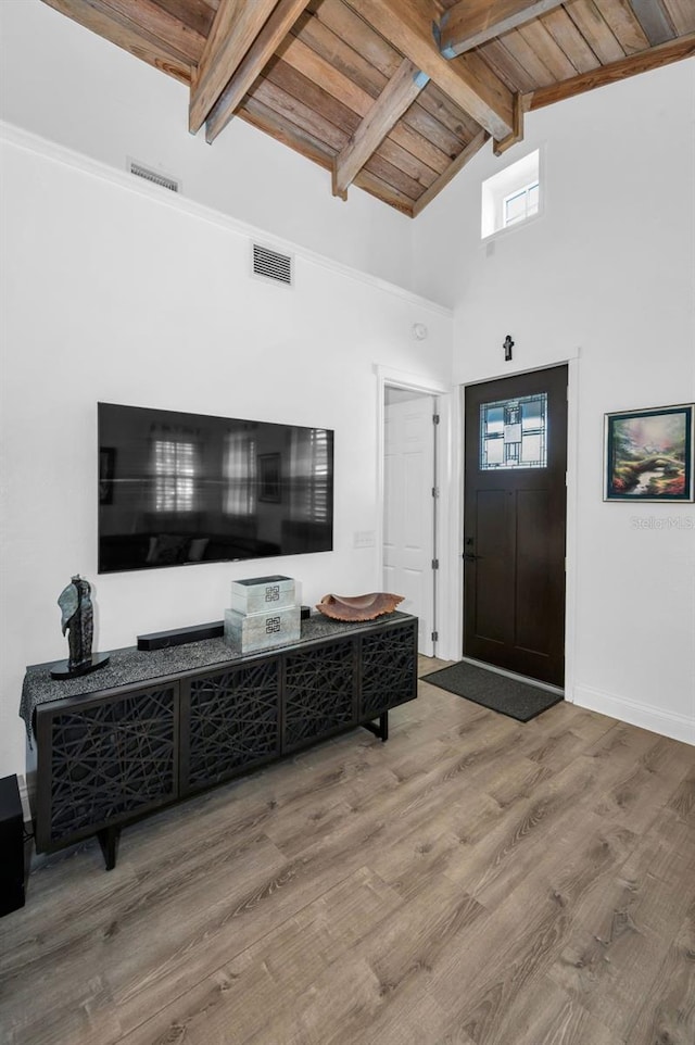 525 Lexington St, Dunedin, FL 34698 - entryway featuring wood finished floors, wooden ceiling with exposed beams, high vaulted ceiling, and baseboards