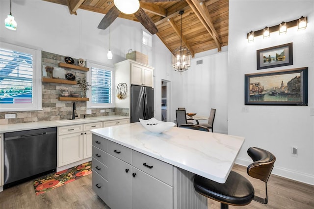 525 Lexington St, Dunedin, FL 34698 - kitchen with dishwasher, stainless steel refrigerator, wood ceiling, a sink, and wood finished floors