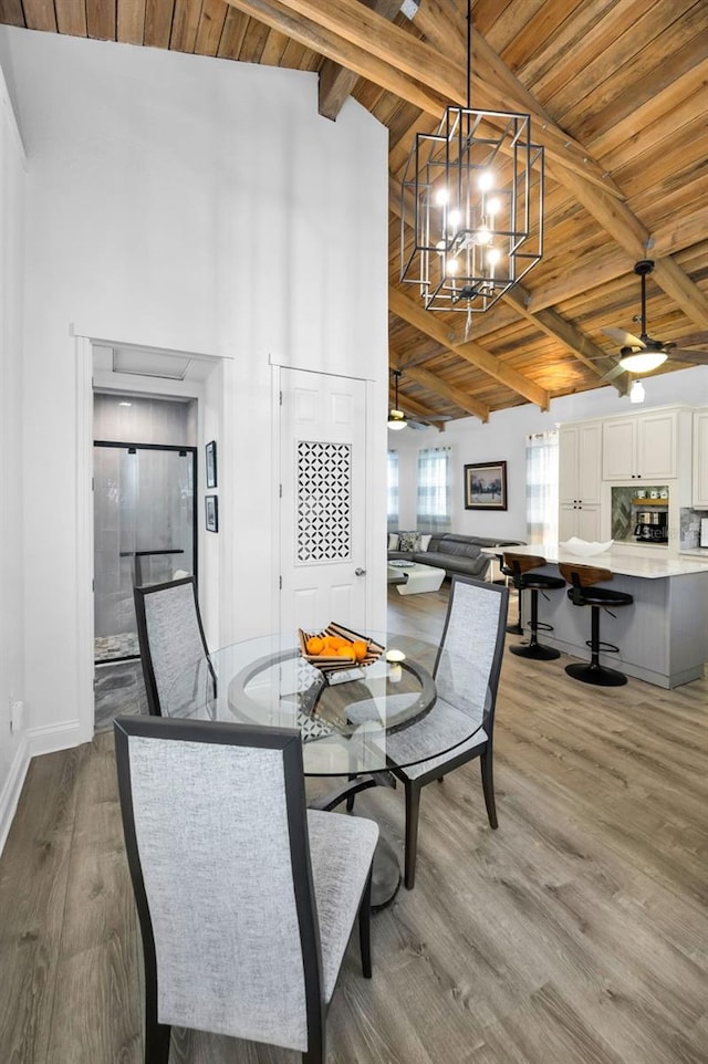 525 Lexington St, Dunedin, FL 34698 - dining room with wood ceiling with exposed beams, high vaulted ceiling, a chandelier, light wood-type flooring, and baseboards