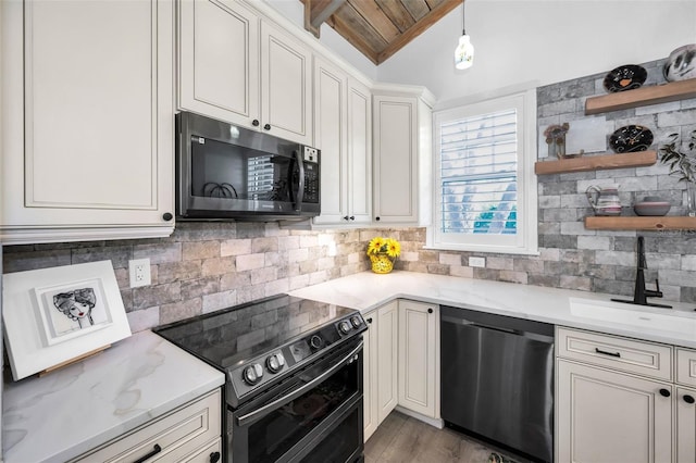 525 Lexington St, Dunedin, FL 34698 - kitchen with stainless steel dishwasher, double oven range, vaulted ceiling, open shelves, and tasteful backsplash
