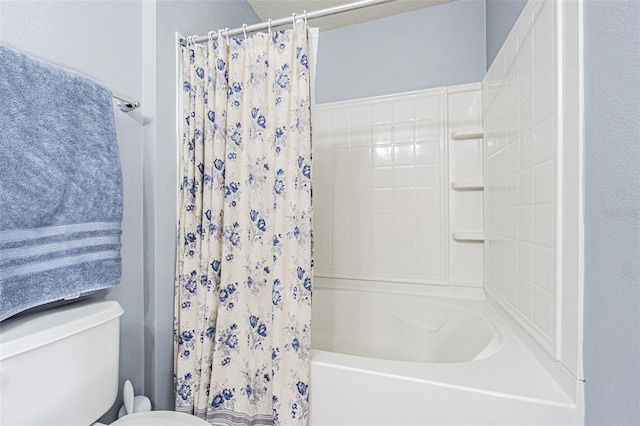 bathroom with toilet and shower / tub combo