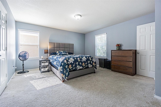 bedroom featuring carpet flooring, baseboards, and multiple windows