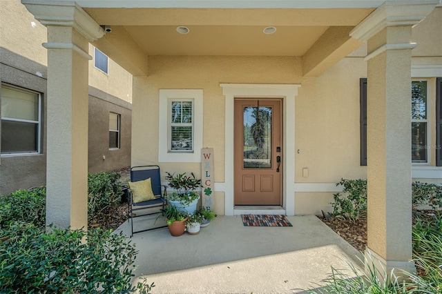 property entrance featuring stucco siding