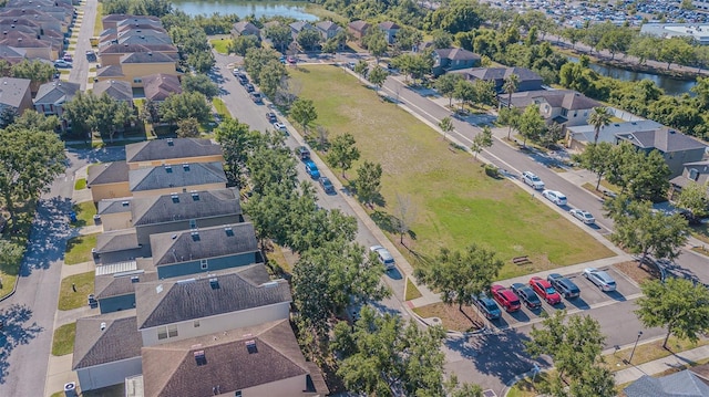 drone / aerial view with a residential view and a water view