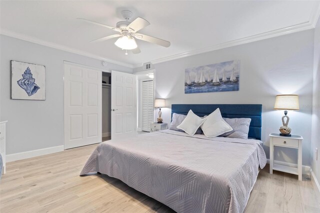 bedroom with crown molding, visible vents, and light wood-style flooring