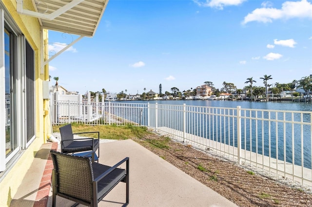 view of patio featuring a fenced backyard, a water view, and a residential view