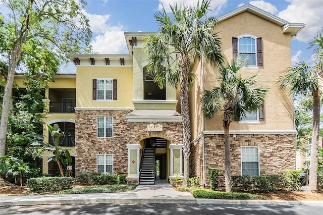 10103 Courtney Oaks Cir Unit 103, Tampa, FL 33619 - view of front of property with stucco siding and stone siding