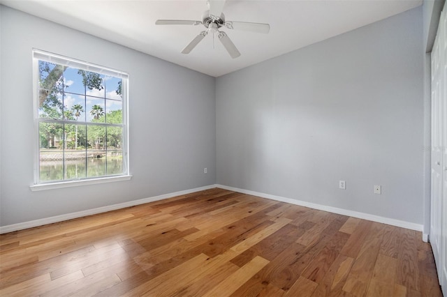 10103 Courtney Oaks Cir Unit 103, Tampa, FL 33619 - spare room featuring light wood finished floors, baseboards, a ceiling fan, and a healthy amount of sunlight