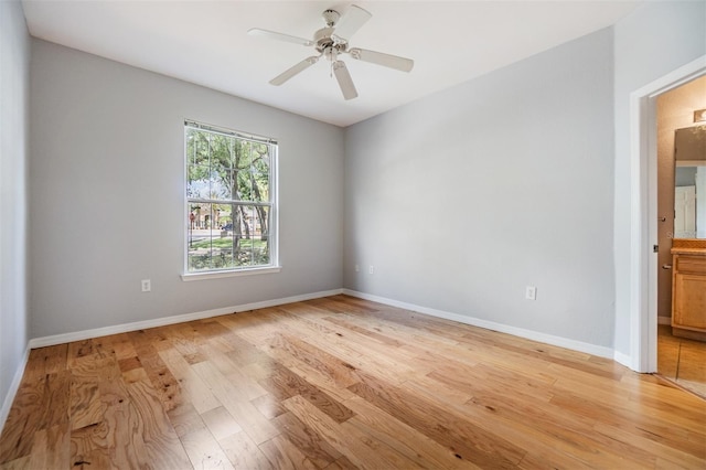 10103 Courtney Oaks Cir Unit 103, Tampa, FL 33619 - spare room with light wood finished floors, baseboards, and ceiling fan