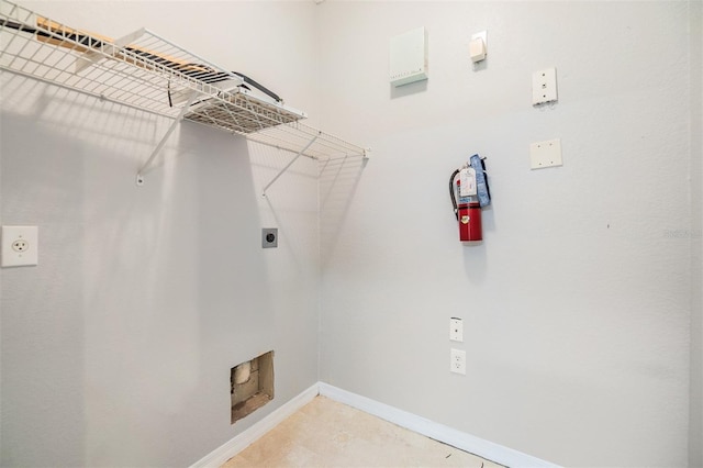 10103 Courtney Oaks Cir Unit 103, Tampa, FL 33619 - clothes washing area featuring laundry area, baseboards, and electric dryer hookup