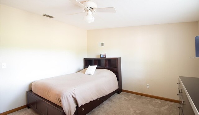 1691 Ridge Top Dr, Tarpon Springs, FL 34688 - bedroom with light colored carpet, baseboards, and visible vents