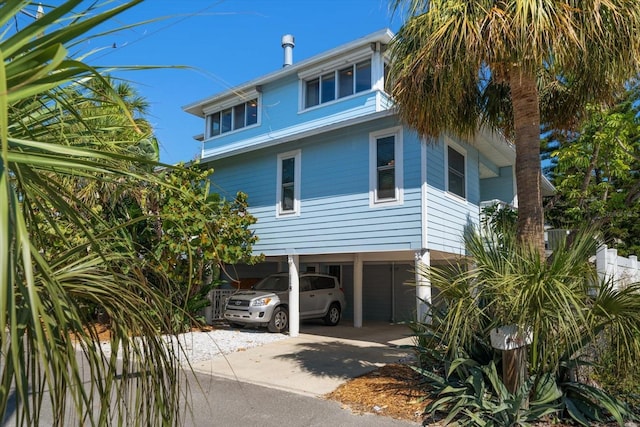118 94th Ave, Treasure Island, FL 33706 - coastal inspired home featuring a carport and concrete driveway