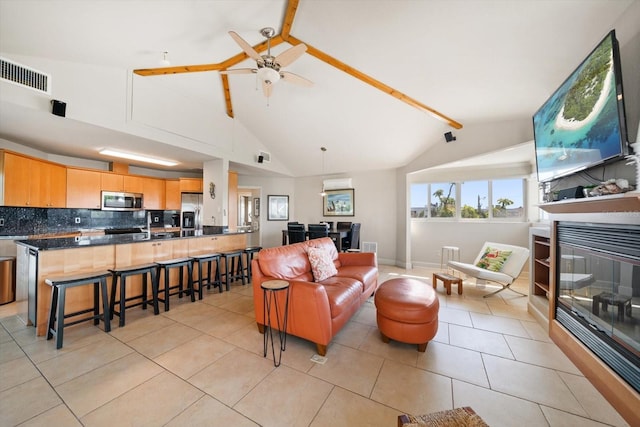 118 94th Ave, Treasure Island, FL 33706 - living room with a glass covered fireplace, lofted ceiling with beams, light tile patterned floors, visible vents, and ceiling fan