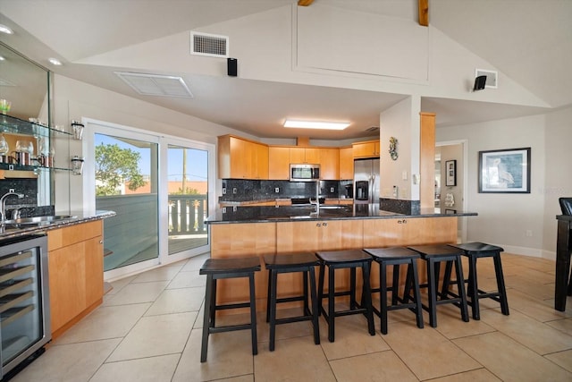 118 94th Ave, Treasure Island, FL 33706 - kitchen with visible vents, a sink, stainless steel appliances, backsplash, and beverage cooler