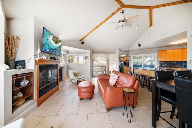 118 94th Ave, Treasure Island, FL 33706 - living area with a glass covered fireplace, plenty of natural light, vaulted ceiling, and a ceiling fan