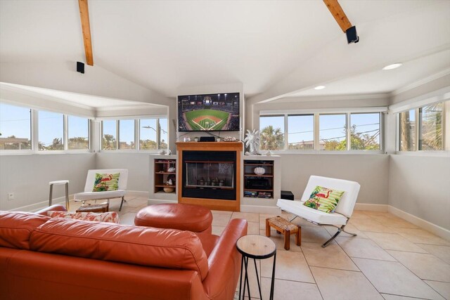 118 94th Ave, Treasure Island, FL 33706 - living area featuring a healthy amount of sunlight, lofted ceiling with beams, and baseboards