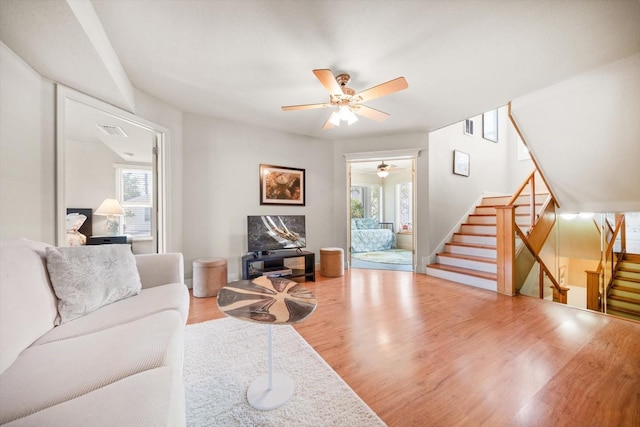 118 94th Ave, Treasure Island, FL 33706 - living area featuring visible vents, a ceiling fan, stairs, and a healthy amount of sunlight