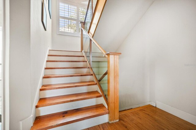 118 94th Ave, Treasure Island, FL 33706 - stairway featuring baseboards and wood finished floors