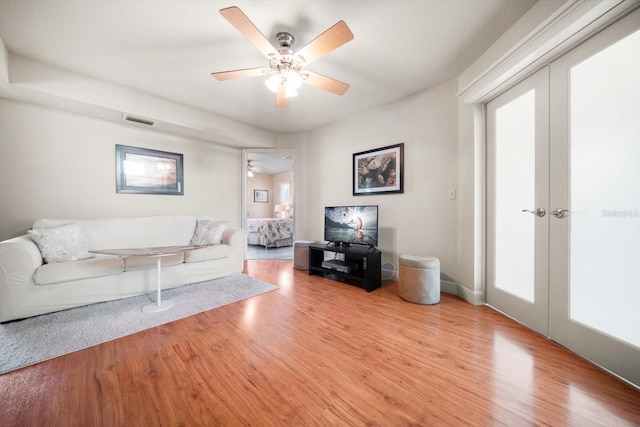 118 94th Ave, Treasure Island, FL 33706 - living room with light wood finished floors, a ceiling fan, and visible vents