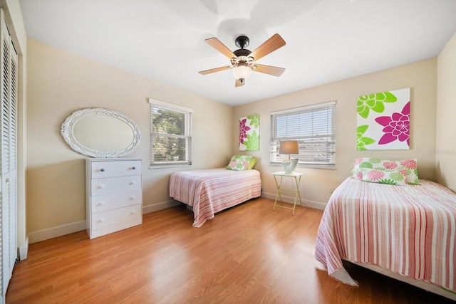 118 94th Ave, Treasure Island, FL 33706 - bedroom featuring a closet, ceiling fan, baseboards, and wood finished floors