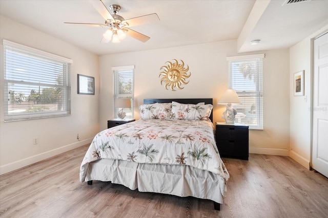 118 94th Ave, Treasure Island, FL 33706 - bedroom featuring light wood-style flooring, multiple windows, and baseboards
