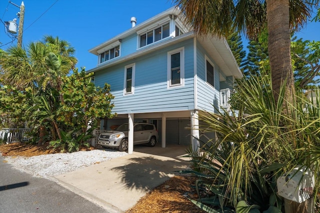 118 94th Ave, Treasure Island, FL 33706 - view of property exterior featuring a carport and concrete driveway