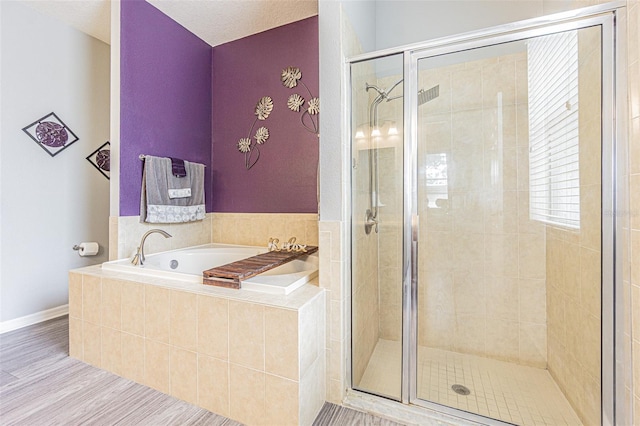 bathroom featuring a shower stall and a garden tub