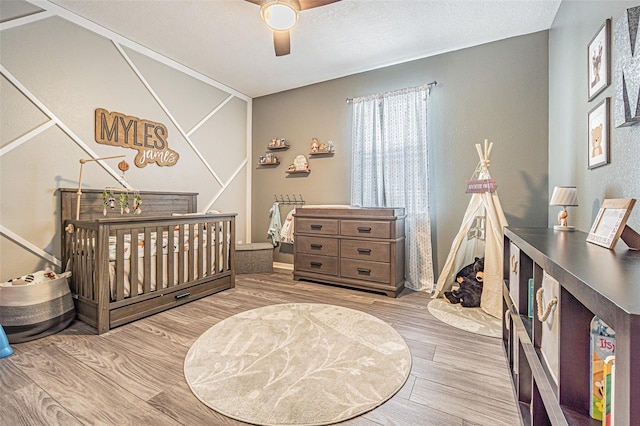 bedroom with a ceiling fan and wood finished floors