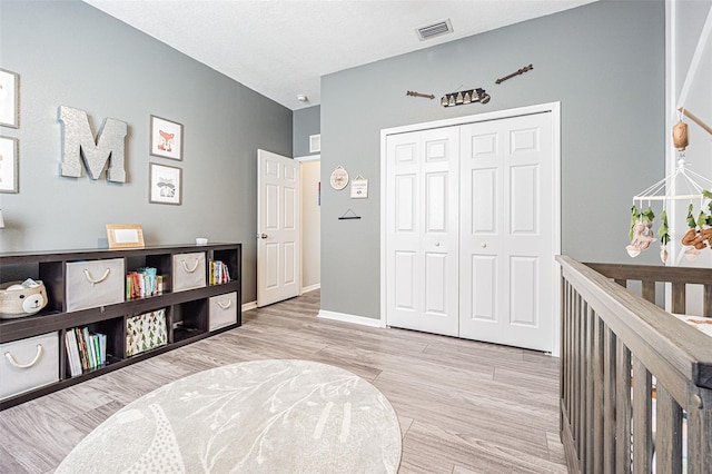 interior space with visible vents, wood finished floors, and baseboards