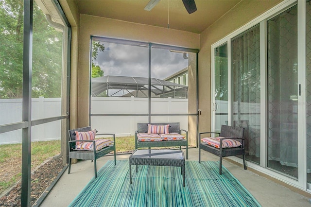 sunroom / solarium with a ceiling fan