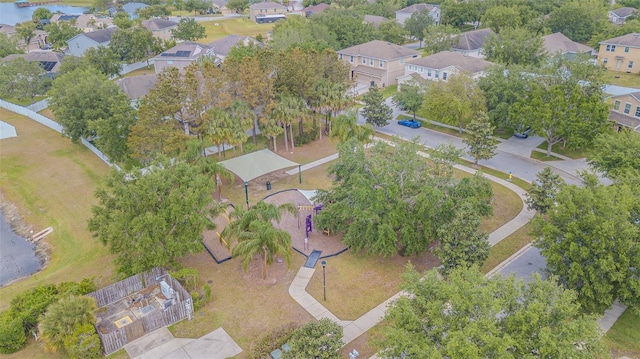 birds eye view of property with a water view and a residential view