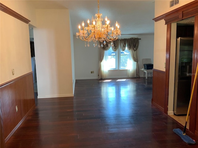 819 Satinleaf Ave, Oldsmar, FL 34677 - unfurnished dining area with a chandelier, a wainscoted wall, wood finished floors, and wood walls