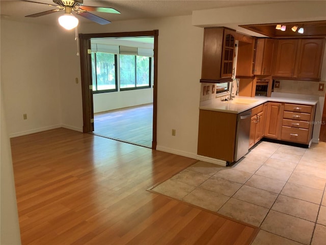 819 Satinleaf Ave, Oldsmar, FL 34677 - kitchen featuring dishwasher, light wood finished floors, light countertops, and ceiling fan