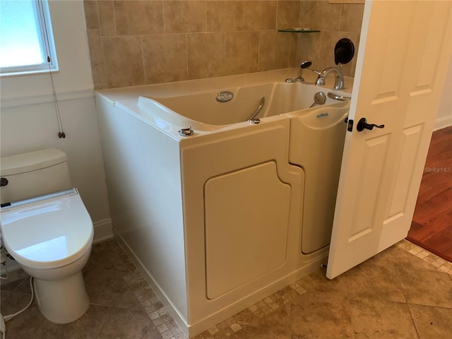 819 Satinleaf Ave, Oldsmar, FL 34677 - bathroom with a bathtub and tile patterned floors