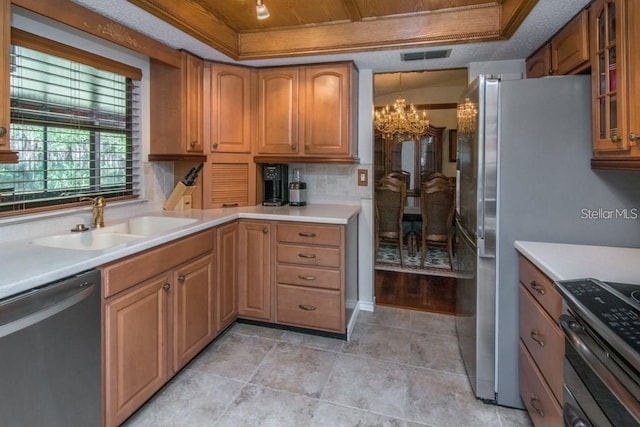 819 Satinleaf Ave, Oldsmar, FL 34677 - kitchen featuring stainless steel appliances, a tray ceiling, a chandelier, light countertops, and wood ceiling