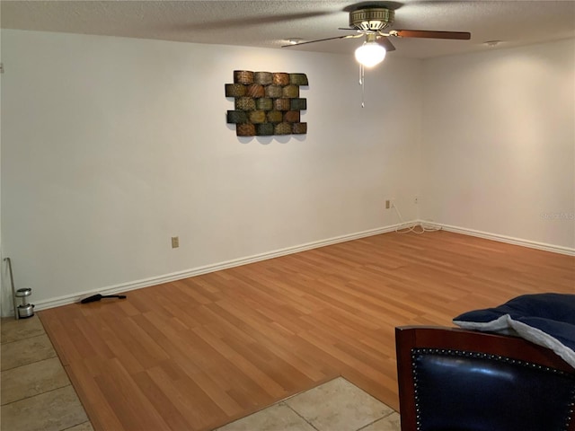 819 Satinleaf Ave, Oldsmar, FL 34677 - unfurnished living room with ceiling fan, light wood-type flooring, and a textured ceiling