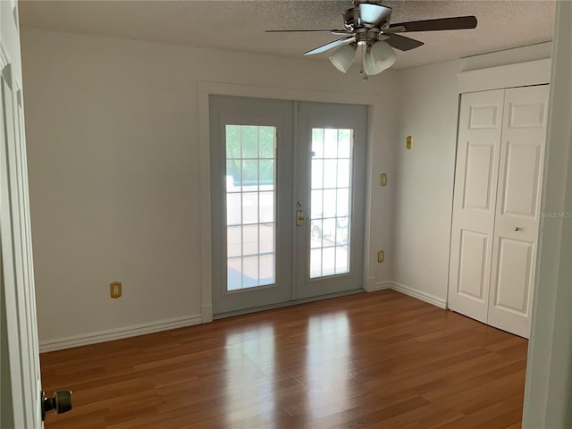 819 Satinleaf Ave, Oldsmar, FL 34677 - doorway to outside with french doors, wood finished floors, a textured ceiling, and ceiling fan