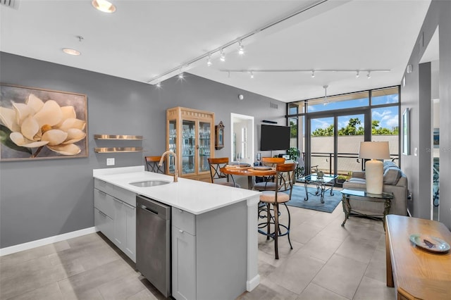 400 4th Ave S Unit 401, Saint Petersburg, FL 33701 - kitchen featuring track lighting, dishwasher, a sink, light countertops, and a peninsula