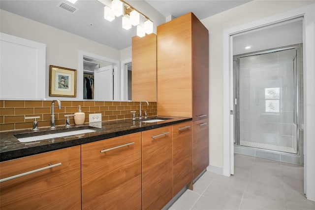 400 4th Ave S Unit 401, Saint Petersburg, FL 33701 - full bathroom with a shower stall, visible vents, a sink, and backsplash
