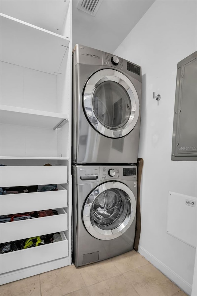 400 4th Ave S Unit 401, Saint Petersburg, FL 33701 - laundry area featuring laundry area, visible vents, electric panel, stacked washer / dryer, and tile patterned floors
