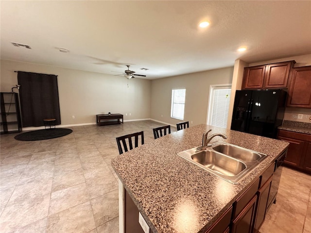 12717 Lemon Pepper Dr, Riverview, FL 33578 - kitchen with black fridge with ice dispenser, a center island with sink, a ceiling fan, open floor plan, and recessed lighting