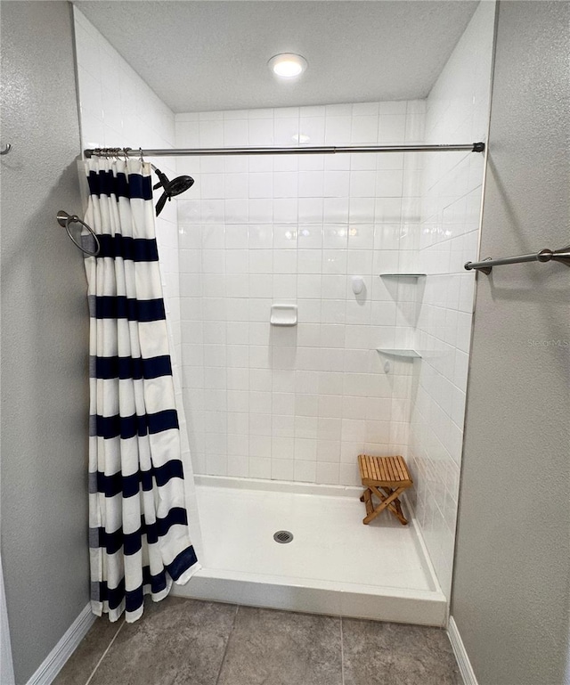 12717 Lemon Pepper Dr, Riverview, FL 33578 - full bathroom with tiled shower, tile patterned floors, and a textured wall