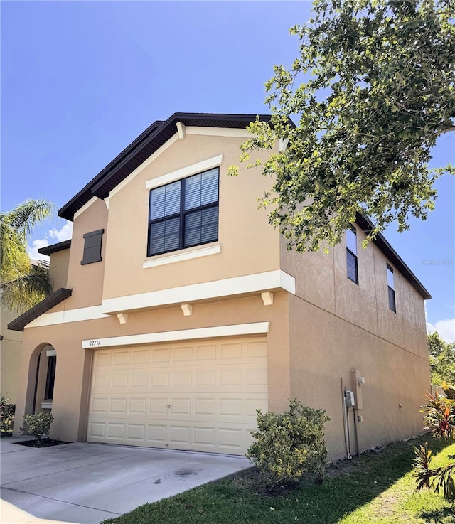 12717 Lemon Pepper Dr, Riverview, FL 33578 - view of front of home with a garage, stucco siding, and driveway